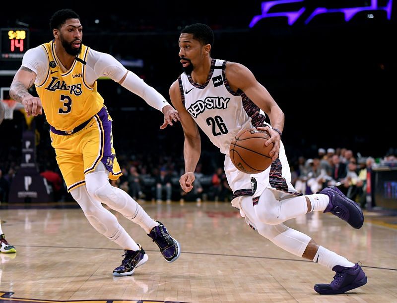 Spencer Dinwiddie #26 drives to the basket on Anthony Davis #3