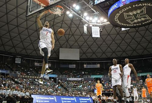 Amir Coffey #7 dunks the ball