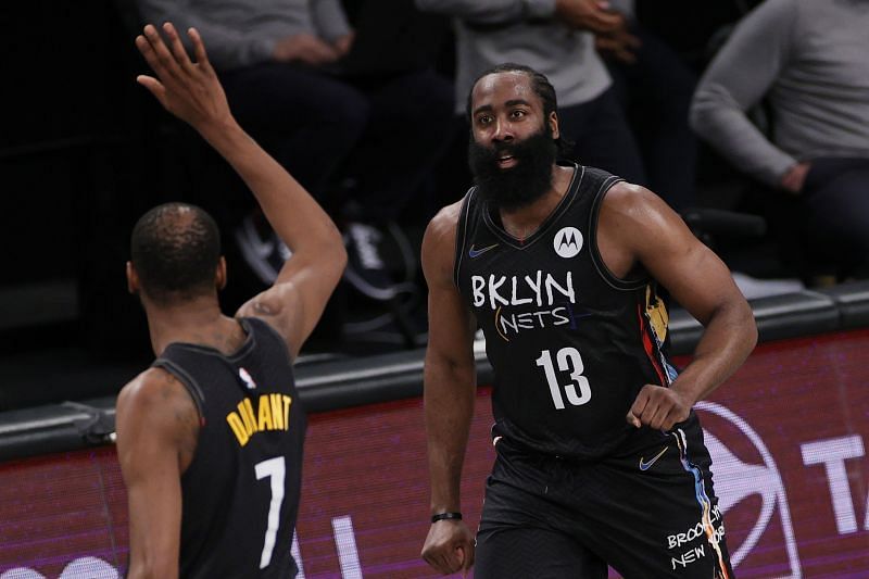 James Harden #13 reacts with Kevin Durant #7 of the Brooklyn Nets