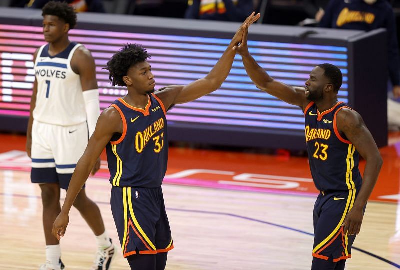 James Wiseman #33 high-fives Draymond Green #23 of the Golden State Warriors.