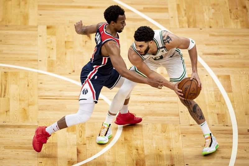 Jayson Tatum #0 of the Boston Celtics controls the ball against Ish Smith #14 of the Washington Wizards