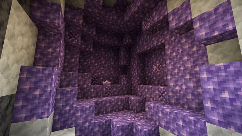 An amethyst geode, signified by the surrounding calcite and smooth basalt blocks, can be found underground. (Image via Minecraft)