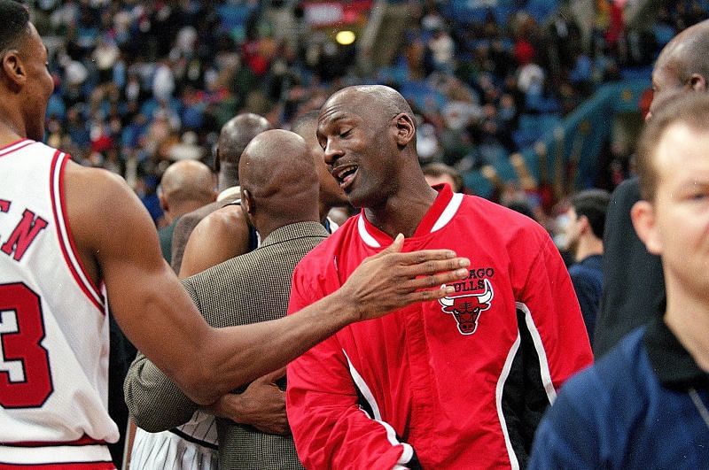 Michael Jordan (#23) talks with teammate Scottie Pippen.