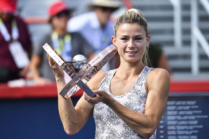 Giorgi with the winner&#039;s trophy at the final presentation ceremony.