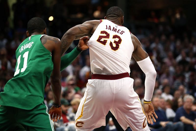 Kyrie Irving and LeBron James (right) face off against each other during an NBA game.