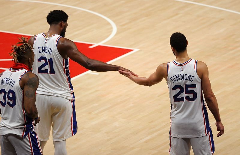 Joel Embiid #21 and Ben Simmons #25 high five in the final minutes of a game