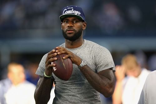 NBA player Lebron James prepares to throw a football at AT&T Stadium