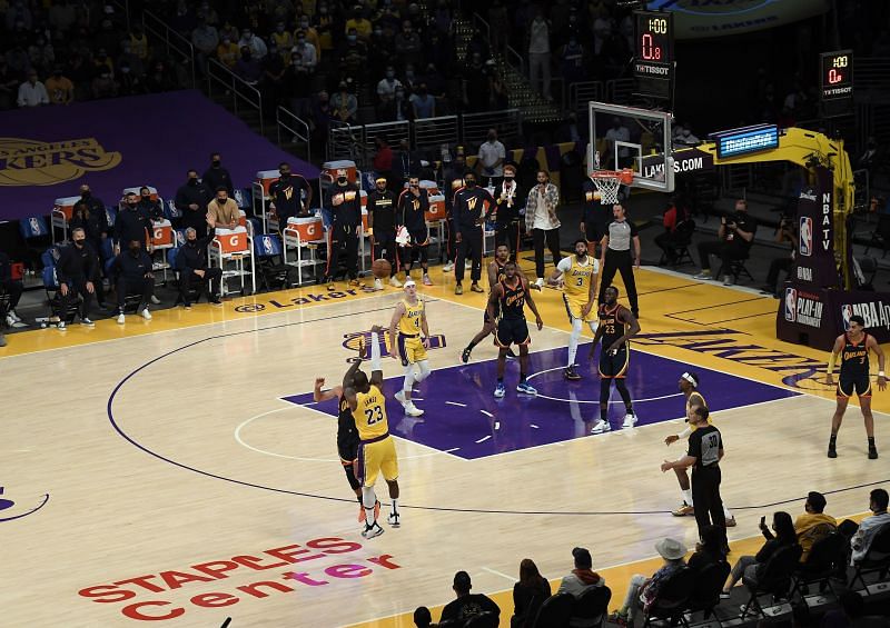 LeBron James (#23) of the LA Lakers scores the game-winning three-point basket against Stephen Curry (#30) of the Golden State Warriors in the NBA Play-In tournament.
