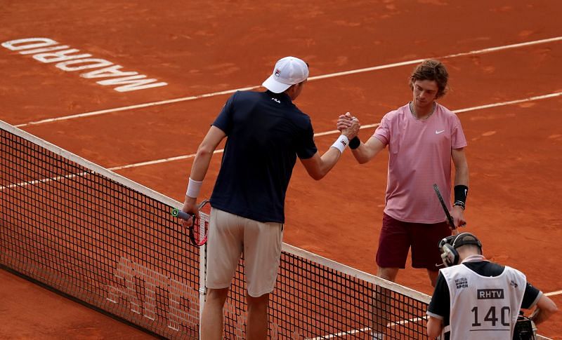 John Isner shakes hands with Andrey Rublev after their encounter in Madrid