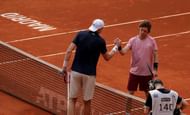 John Isner shakes hands with Andrey Rublev after their encounter in Madrid