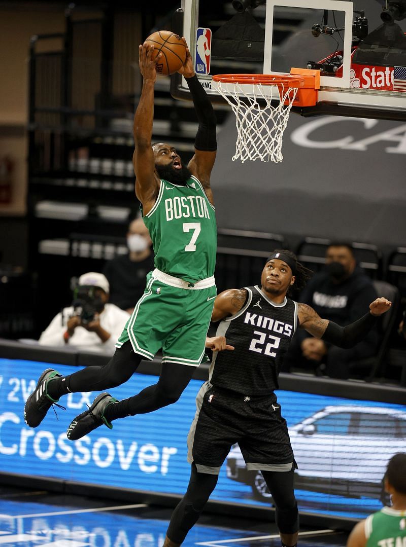 Jaylen Brown (#7) of the Boston Celtics dunks on Richaun Holmes (#22) of the Sacramento Kings.