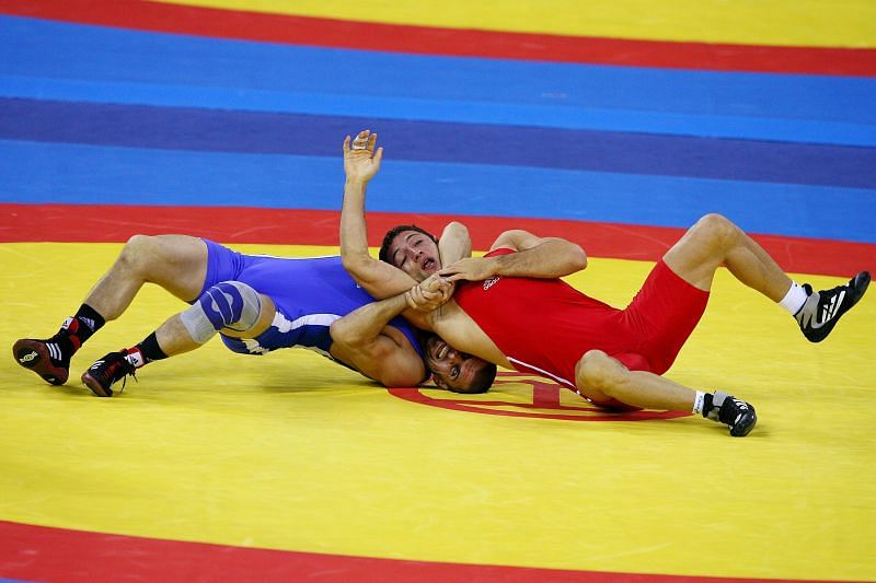 Murad Gaidarov (in Blue ) of Belarus wrestles Gheorghita Stefan of Romania during the 74kg Men&#039;s Freestyle wrestling of the Beijing 2008 Olympic