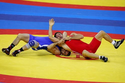 Murad Gaidarov (in Blue ) of Belarus wrestles Gheorghita Stefan of Romania during the 74kg Men's Freestyle wrestling of the Beijing 2008 Olympic