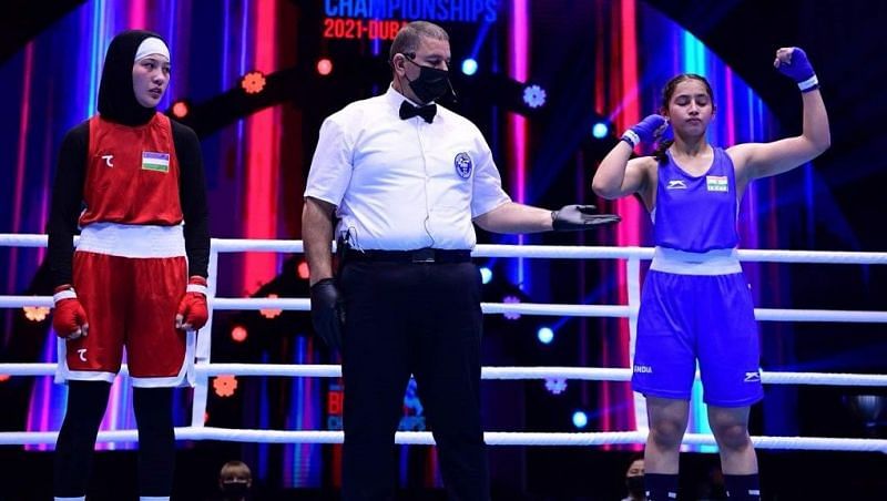 Indian boxer Nikita Chand (in blue) exults after winning her semi-final bout.