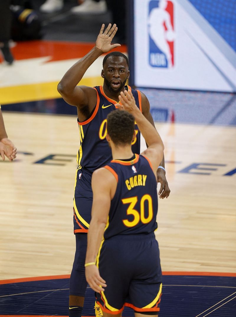 Draymond Green #23 high-fives Stephen Curry #30 of the Golden State Warriors