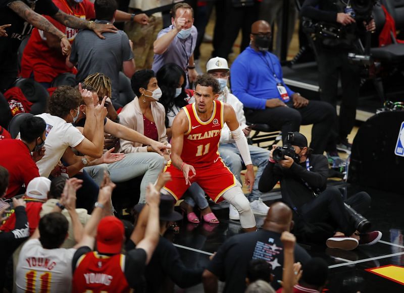 Trae Young (#11) of the Atlanta Hawks celebrates a basket with fans.