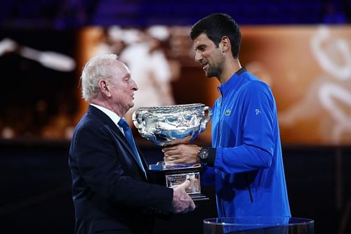 Novak Djokovic being presented the 2019 Australian Open title by Rod Laver.