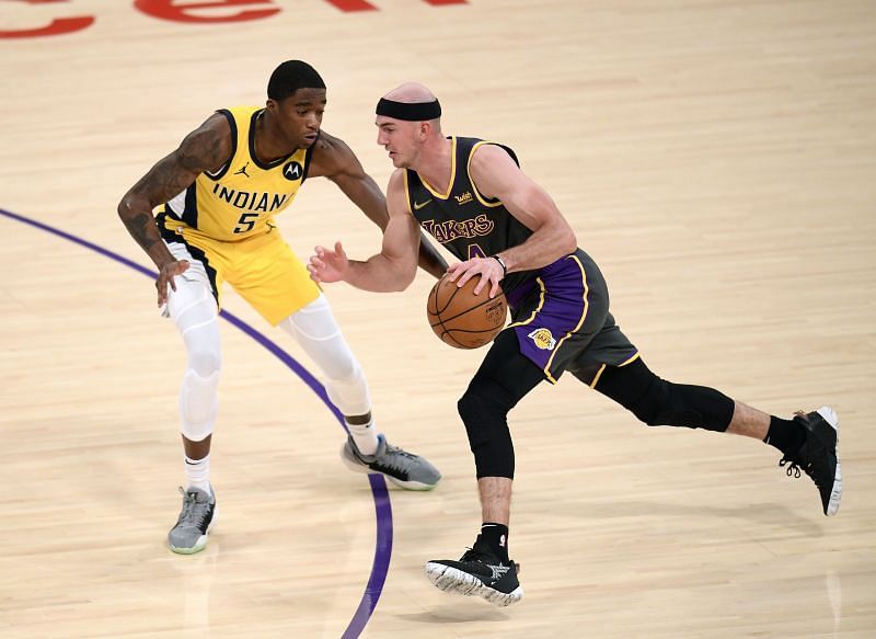 Alex Caruso #4 drives to the basket on Edmond Sumner #5.