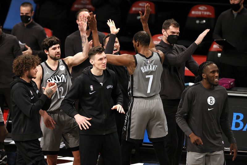 Brooklyn Nets bench high-fives Kevin Durant (#7) after the second half against the Atlanta Hawks at the Barclays Center on December 30, 2020.