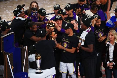 Lakers players celebrate with the Larry O'Brien Trophy