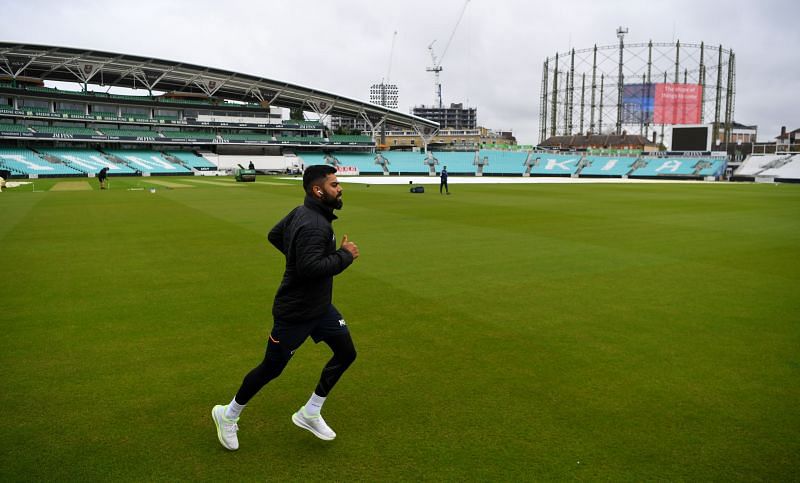 Indian captain Virat Kohli walks up ahead of a nets session.