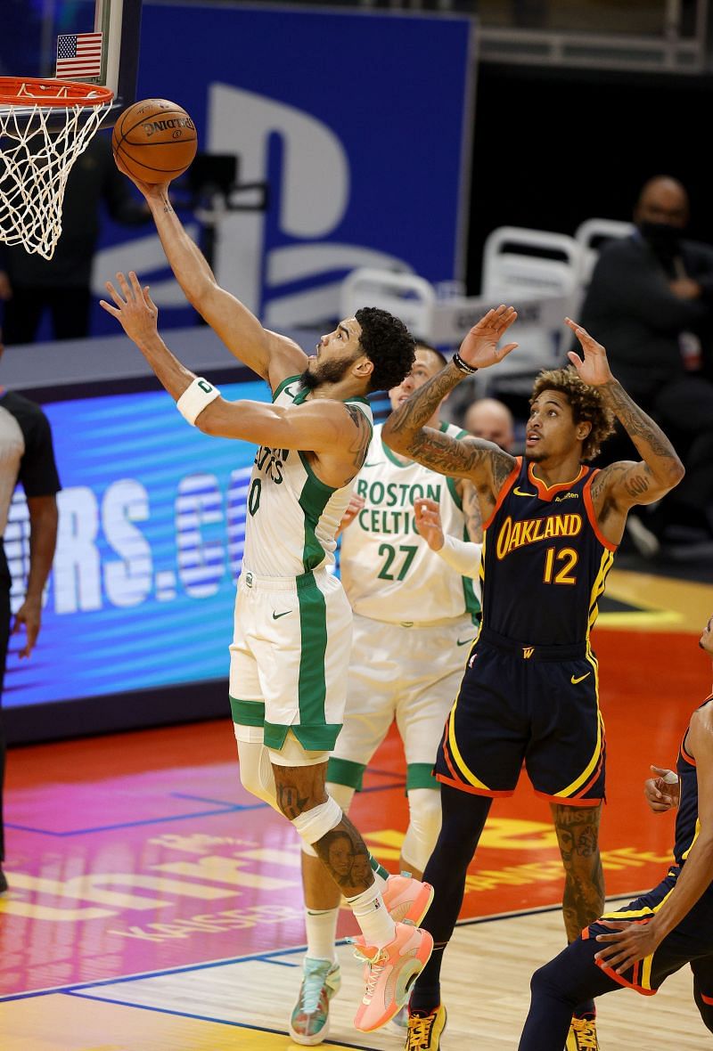 ayson Tatum #0 of the Boston Celtics goes up for a shot on Kelly Oubre Jr. #12 of the Golden State Warriors