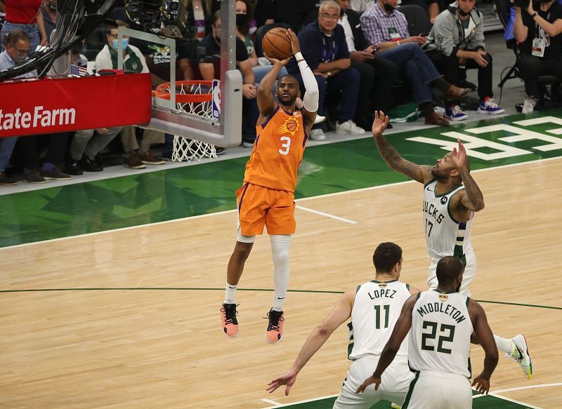 Chris Paul #3 of the Phoenix Suns goes up for a shot against the Milwaukee Bucks.