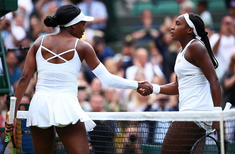 Venus Williams (L) shakes hands with Coco Gauff at Wimbledon 2019