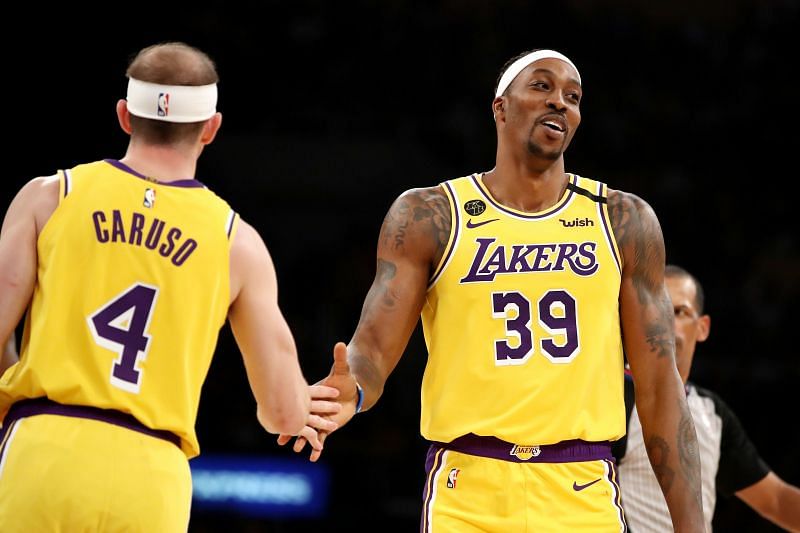 Dwight Howard #39 and Alex Caruso #4 reacts to a play in a game.