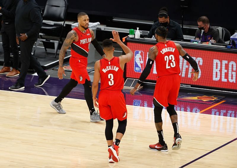 Damian Lillard (#0) of the Portland Trail Blazers celebrates with CJ McCollum (#3).