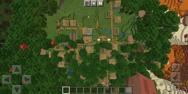 A village with a blacksmith house (Image via Minecraft)