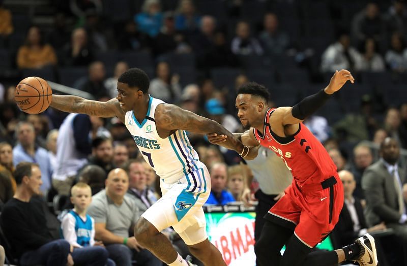 Oshae Brissett #12 tries to stop Dwayne Bacon #7