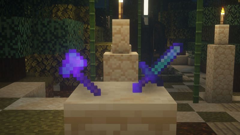 An enchanted diamond sword and ax in the game (Image via Minecraft)