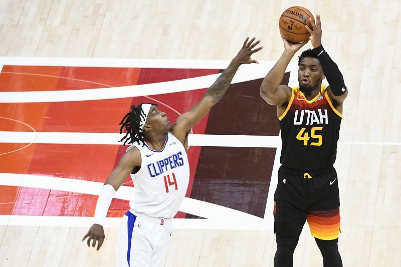 Donovan Mitchell (#45) of the Utah Jazz shoots over Terance Mann (#14) of the LA Clippers.
