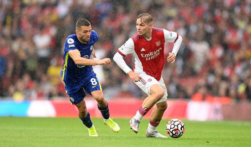 Emile Smith Rowe runs with the ball while under pressure from Mateo Kovacic.