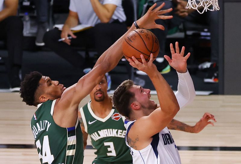 Luka Doncic (right) and Giannis Antetokounmpo (left) clash at the rim