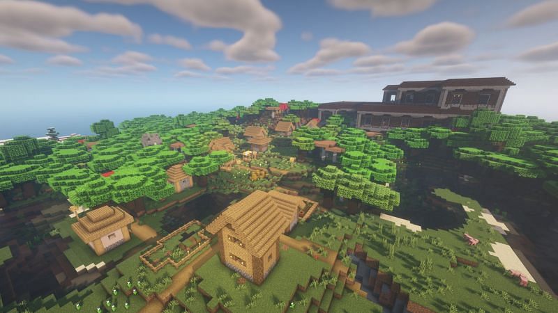 A woodland mansion next to a village (Image via Minecraft)