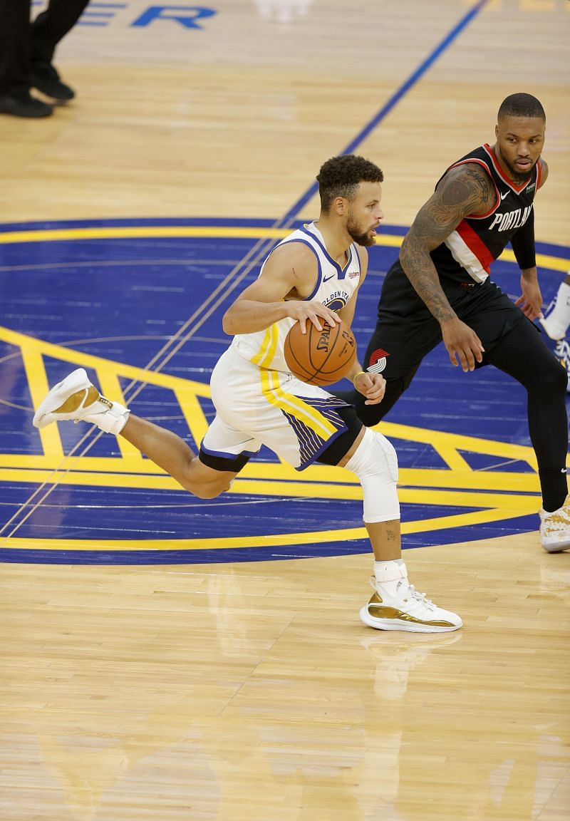 Stephen Curry #30 of the Golden State Warriors is guarded by Damian Lillard #0 of the Portland Trail Blazers