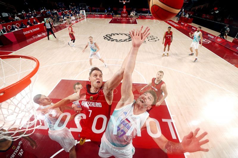 Luka Doncic #77 and Johannes Voigtmann #7 go up for a rebound.
