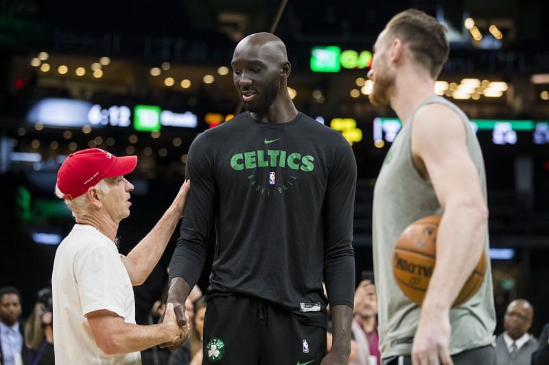 Former tennis player John McEnroe greets Tacko Fall.