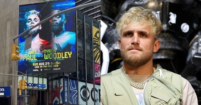 Jake Paul shows off his poster for fight against Tyron Woodley beaming at Times Square