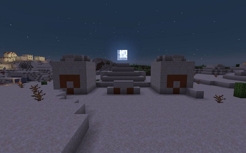The moon rising over a desert temple (Image via Minecraft)