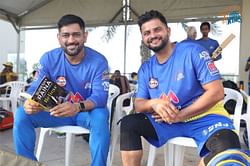 "Thala's touch on my untold story" - Suresh Raina as MS Dhoni poses with his autobiography 'Believe'