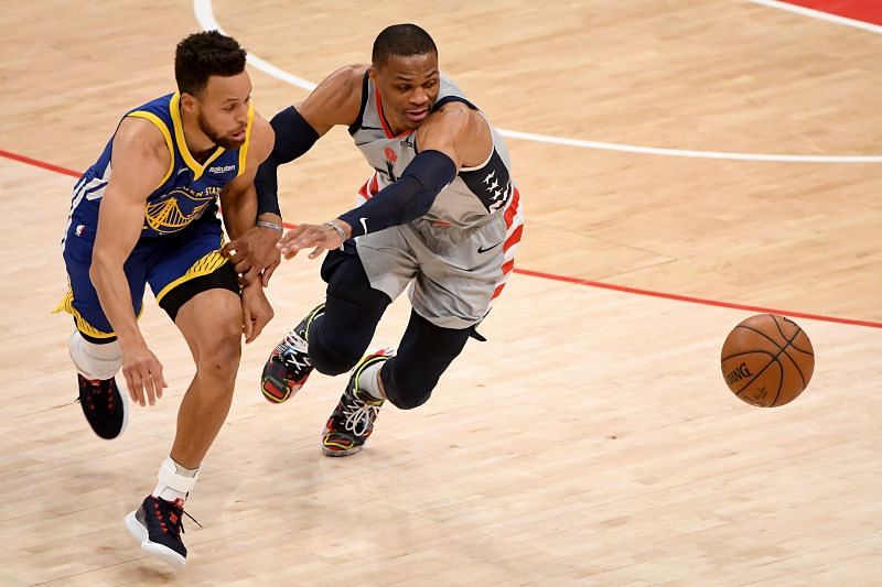 Stephen Curry of the Golden State Warriors goes shoulder-to-shoulder with Russell Westbrook of the Washington Wizards