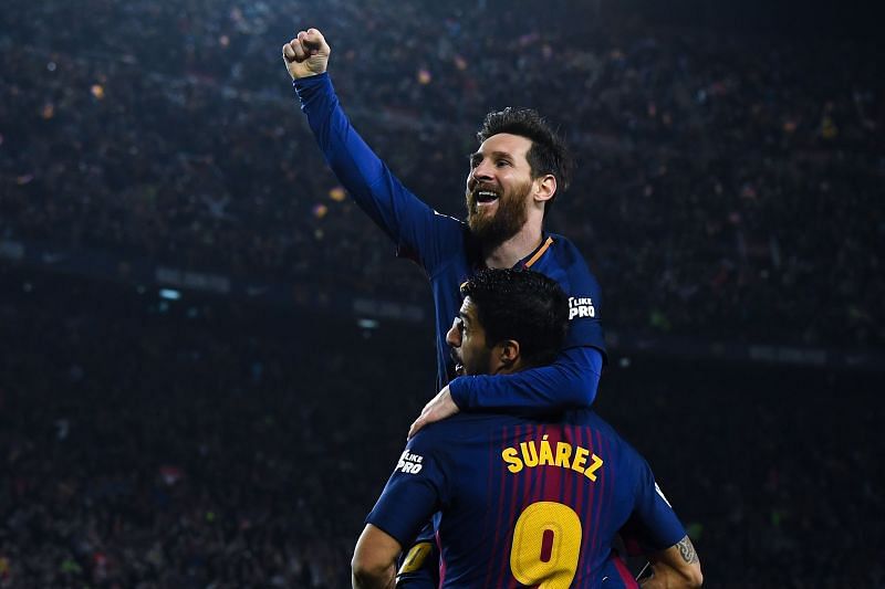 Lionel Messi celebrates with Luis Suarez after scoring his team&#039;s second goal