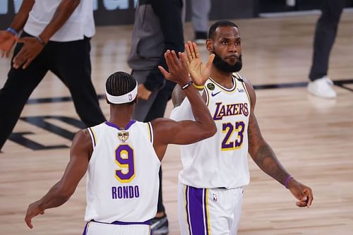 LeBron James #23 high fives Rajon Rondo #9.