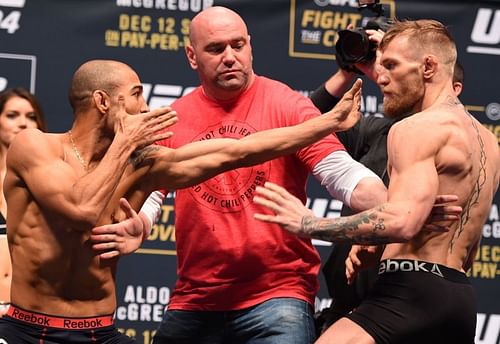 Jose Aldo and Conor McGregor facing off