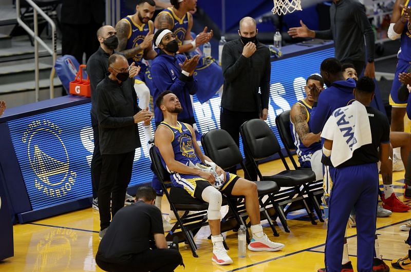 Stephen Curry #30 of the Golden State Warriors is surrounded by teammates applauding him after he made a basket to pass Wilt Chamberlain as the Golden State Warriors all-time leading scorer.