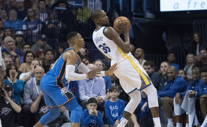 Kevin Durant #35 of the Golden State Warriors works his way around Russell Westbrook #0 of the Oklahoma City Thunder
