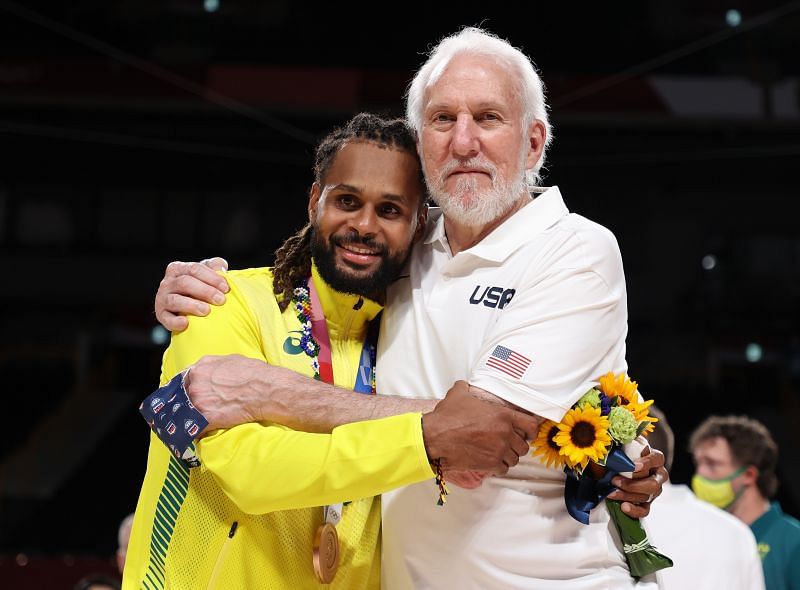 Team United States Head Coach Gregg Popovich poses with Team Australia&#039;s Patty Mills.